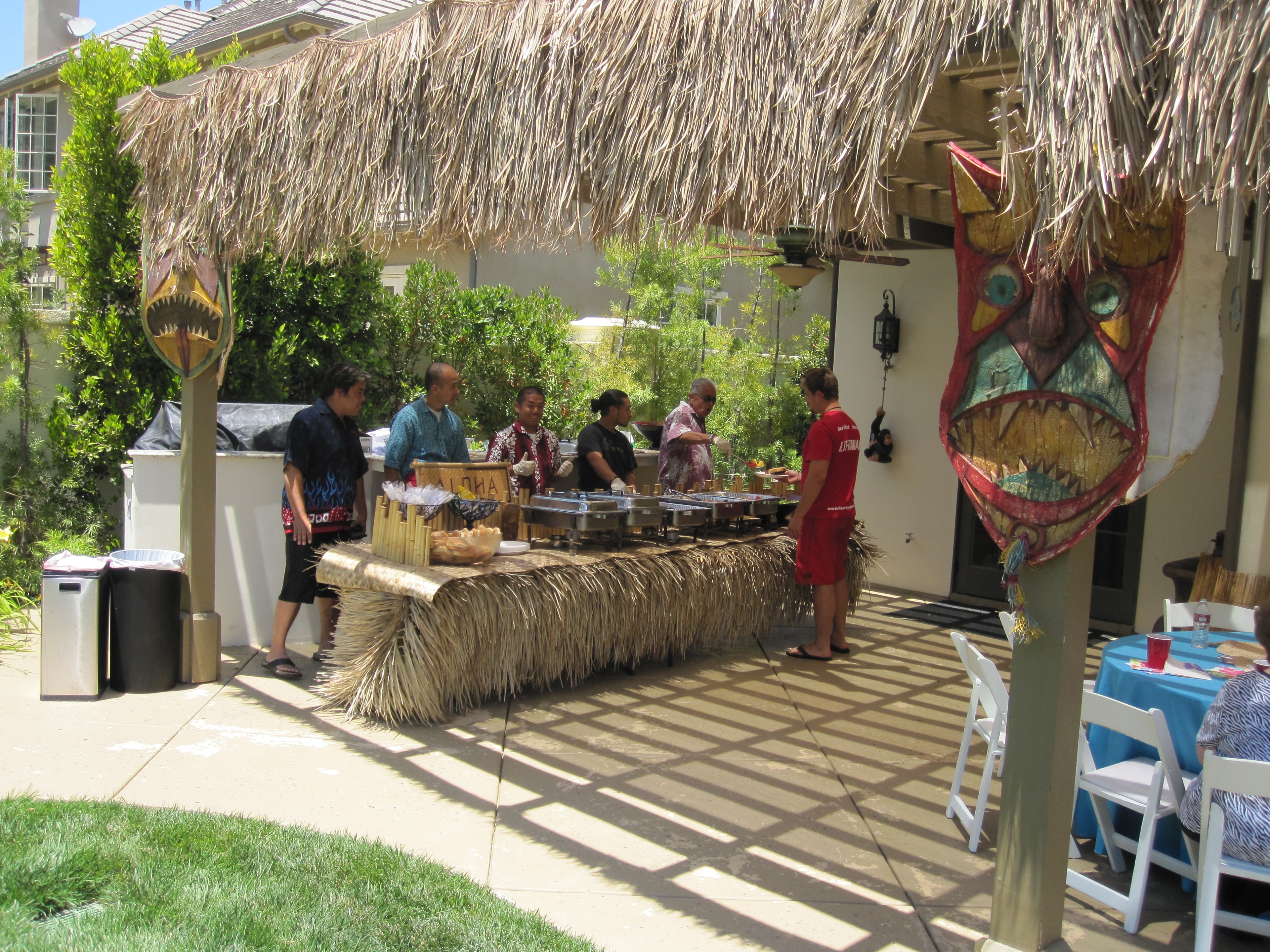 Backyard luau pool party setup with tiki torches and tropical decorations in Las Vegas, NV